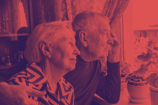 Senior couple looking out the window