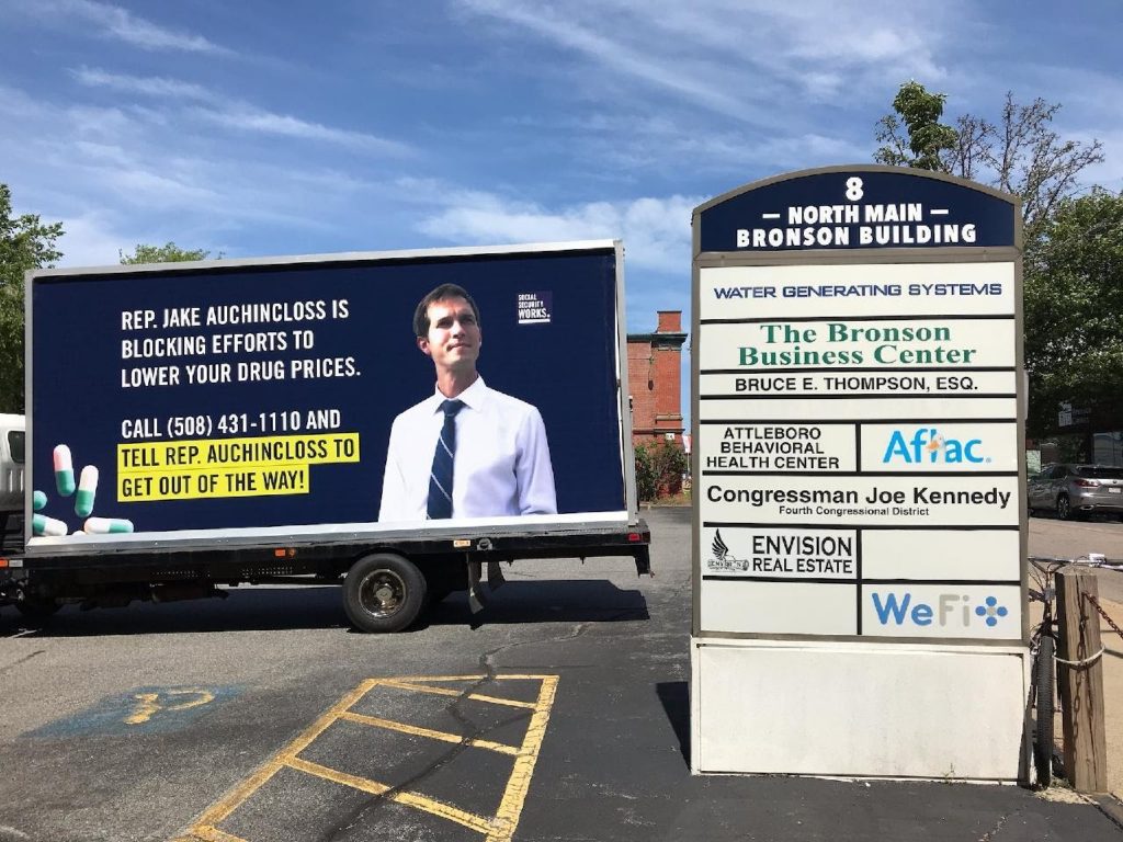 Mobile billboard featuring Jake Auchincloss in shopping center
